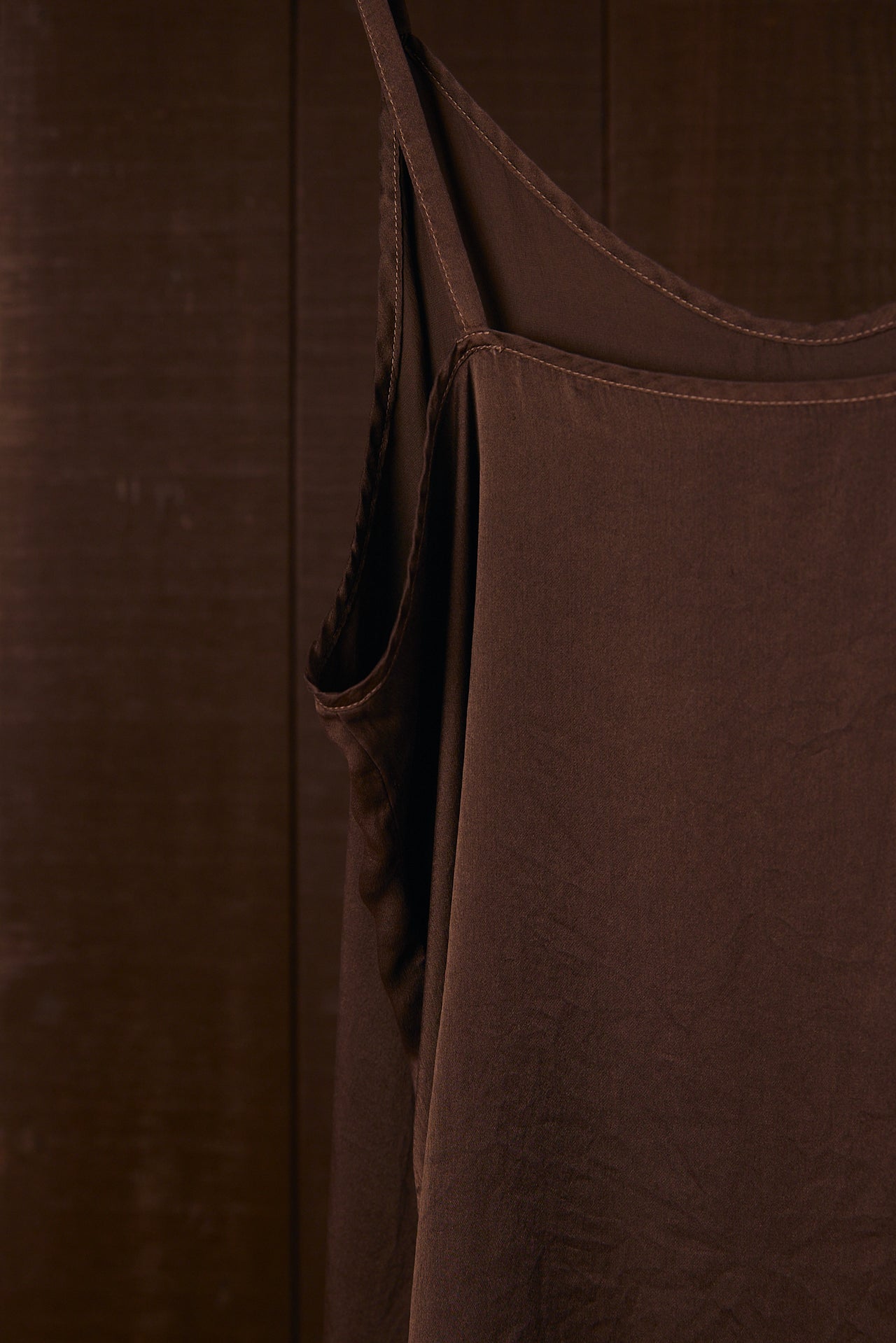 Close-up of a plant dyed silk garment with a strap detail