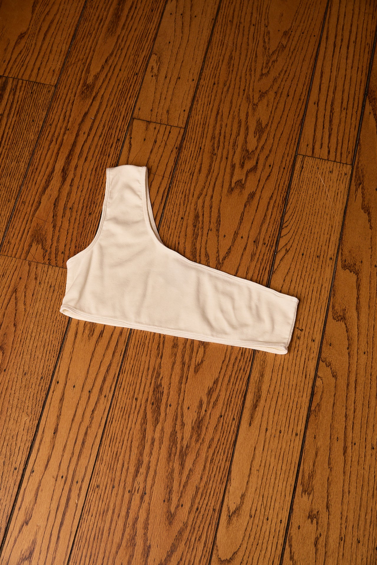 White crop top on a wooden floor