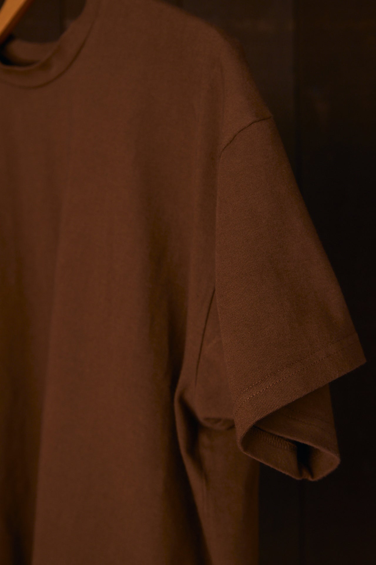 Brown organic cotton t-shirt on a dark background