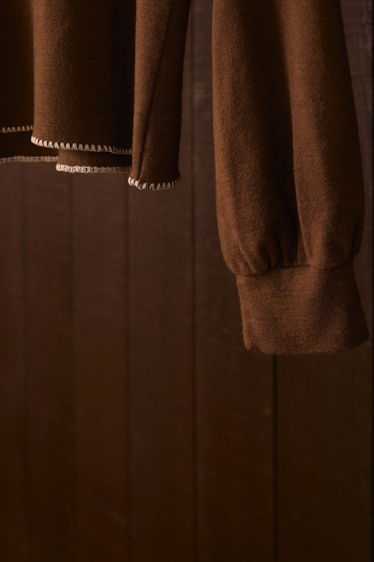 Brown garment with long sleeves on a matching brown background