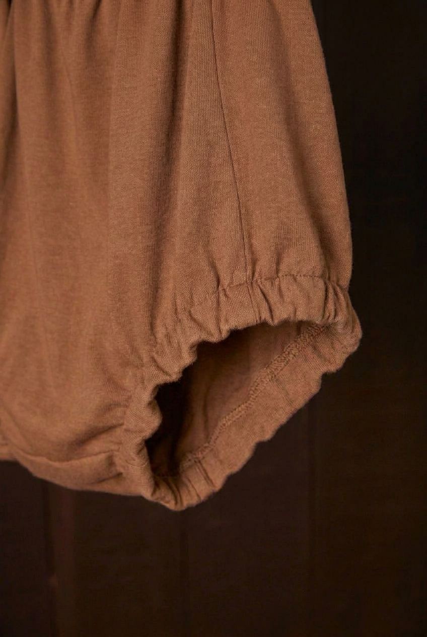 Close-up of the cutch plant-dyed walnut Comfort Bloomer scrunchie leg band
