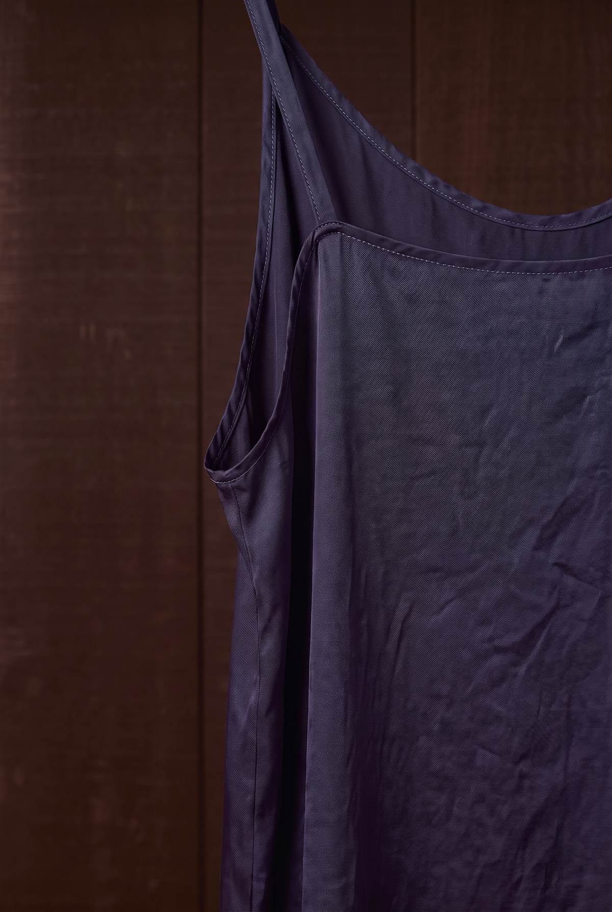 Close-up of indigo silk camisole strap and topstitched neckline